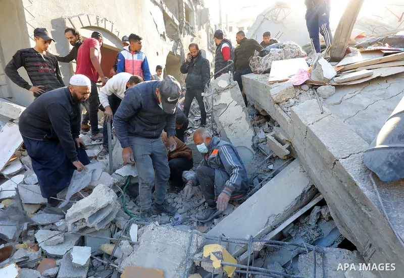 Palestinian residents conduct a search and rescue operation among the destroyed buildings after Israeli attacks in Al-Maghazi, Gaza on December 11, 2023. Photo by Naaman Omar\ apaimages