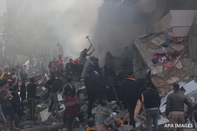 Rescuers and civilians look for survivors amid the rubble of destroyed buildings following Israeli bombardment in Rafah, in the southern Gaza Strip on December 14, 2023, Thousands of Palestinians civilian, have died sinc...