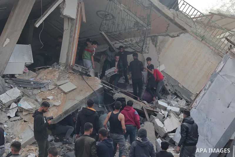 Rescuers and civilians look for survivors amid the rubble of destroyed buildings following Israeli bombardment in Rafah, in the southern Gaza Strip on December 14, 2023, Thousands of Palestinians civilian, have died sinc...