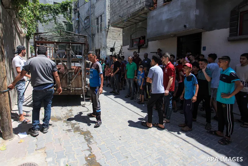 Palestinians gather around calves ahead of Muslim festival of Eid Al-Adha, the Feast of Sacrifice, in Zawaida in the center of Gaza strip on June 27, 2023. Eid al-Adha or the feast of sacrifice, which falls at this month...