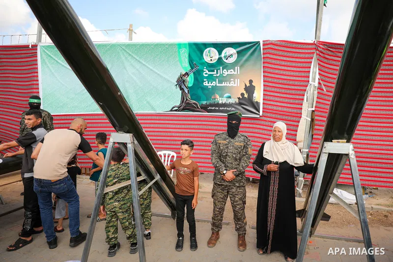 Palestinians attend a weapons exhibition organized by the Al-Qassam Brigades, the military wing of Hamas, in Nuseirat, central Gaza Strip, on the third day of Eid al-Adha on June 30, 2023. “Ezzedeen Al-Qassam Brigades” i...