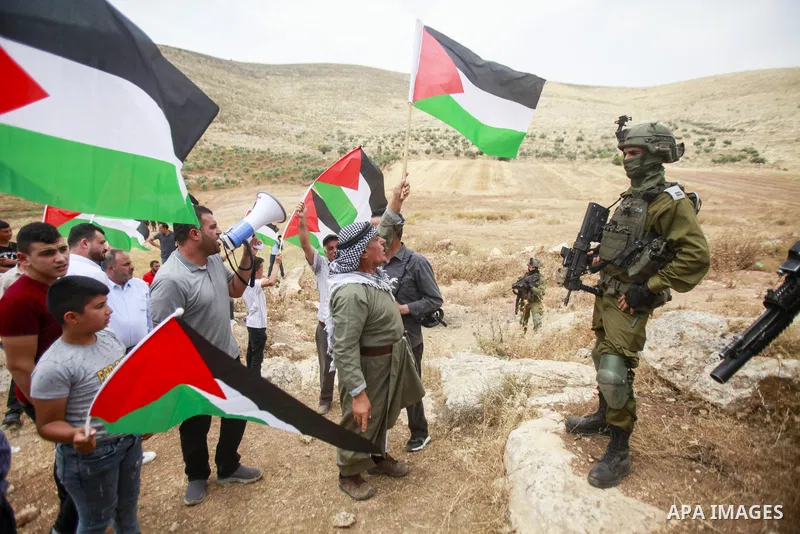 Palestinians argue with Israeli security forces during a protest against the establishment of Israeli outposts, in Beit Dajan, east of the West Bank city of Nablus, on June 2, 2023. Photo by Mohammed Nasser\ apaimages