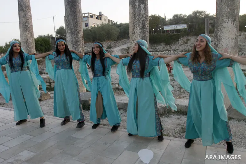 Palestinians attend the "Here We Stay" festival against settlement in the village of Sebastia near the West Bank city of Nablus on June 10, 2023. The ancient town of Sebastia is one of the greatest archaeological sites o...