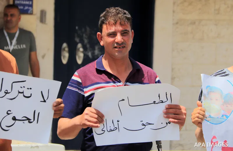 Palestinians of WFP beneficiaries take part in a protest against the stopping of aid, in front of United Nations Development Programme office (UNDP) in Gaza city on May 21, 2023. WFP pauses food distribution in Gaza foll...