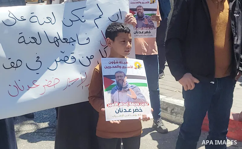 Palestinians take part in a protest following the announcement of the death of a Palestinian hunger striker Khader Adnan who was in Israeli Jails in the West Bank city of Hebron on May 2, 2023. Israel's prison service an...