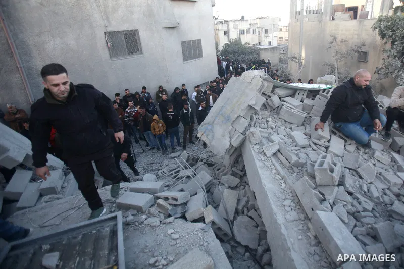 People gather amidst debris after Israeli forces demolished the home of a Palestinian accused of killing an Israeli soldier, in the village of Hares, in the West Bank, on May 3, 2023. The Israeli forces, accompanied by 5...