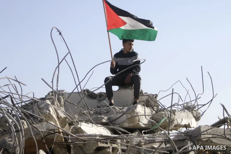 People gather amidst debris after Israeli forces demolished the house of a Palestinian prisoner Younes Hilan in the village of Hajja, east of the West Bank city of Qalqilya on May 3, 2023. Local sources told the Israeli...
