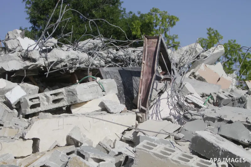People gather amidst debris after Israeli forces demolished the house of a Palestinian prisoner Younes Hilan in the village of Hajja, east of the West Bank city of Qalqilya on May 3, 2023. Local sources told the Israeli...