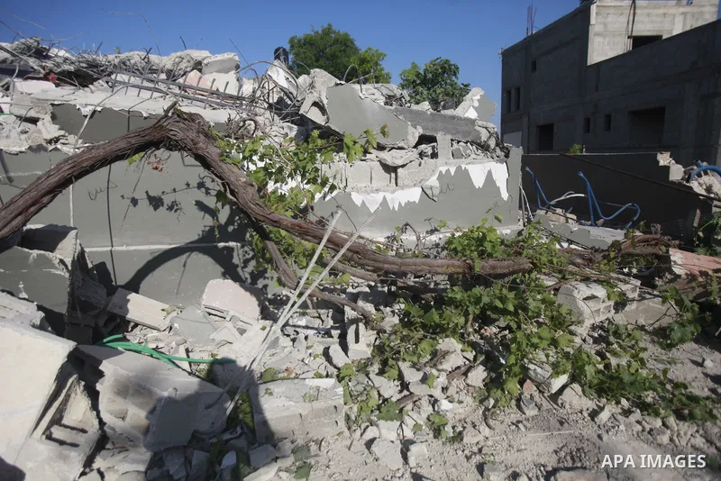 People gather amidst debris after Israeli forces demolished the house of a Palestinian prisoner Younes Hilan in the village of Hajja, east of the West Bank city of Qalqilya on May 3, 2023. Local sources told the Israeli...