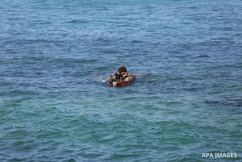 Palestinian fishermen work on the shore of the Mediterranean Sea in Gaza city May 4, 2023. Photo by Bashar Taleb\ apaimages