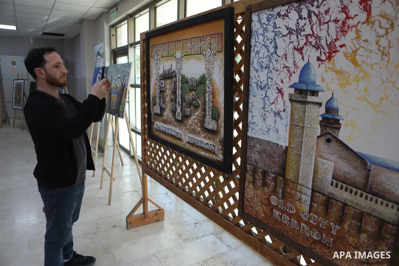 Palestinians attend an exhibition "Lammat al-Khalil" in the West Bank city of Hebron on May 6, 2023. Photo by Mamoun Wazwaz