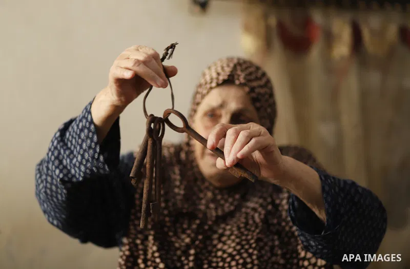This picture taken on May 8, 2023, shows Palestinian refugee Ebthaj Dawla shows the keys to her family house, in her home in Gaza City. Nakba, or "catastrophe", is the event known by Palestinians, during which more than...