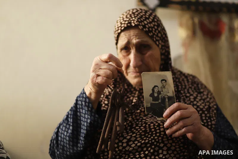 This picture taken on May 8, 2023, shows Palestinian refugee Ebthaj Dawla shows the keys to her family house, in her home in Gaza City. Nakba, or "catastrophe", is the event known by Palestinians, during which more than...