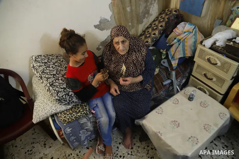 This picture taken on May 8, 2023, shows Palestinian refugee Ebthaj Dawla shows the keys to her family house, in her home in Gaza City. Nakba, or "catastrophe", is the event known by Palestinians, during which more than...