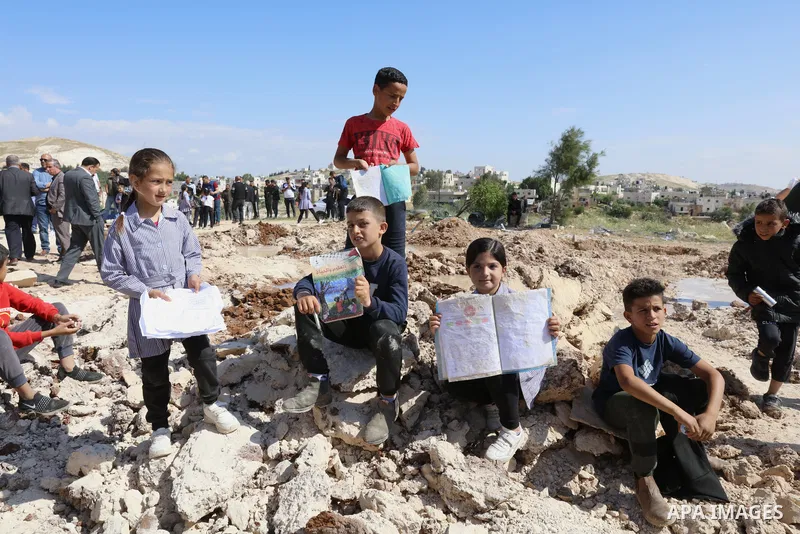 Palestinians gather near the damage of Jibb Al-Deeb School demolished by Israeli authorities in the small Palestinian village of Bayt Ta’mar, to the east of Bethlehem in the south of the West Bank on May 7, 2023. Israeli...