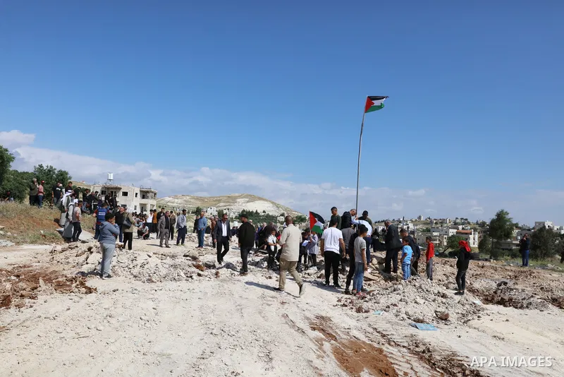 Palestinians gather near the damage of Jibb Al-Deeb School demolished by Israeli authorities in the small Palestinian village of Bayt Ta’mar, to the east of Bethlehem in the south of the West Bank on May 7, 2023. Israeli...