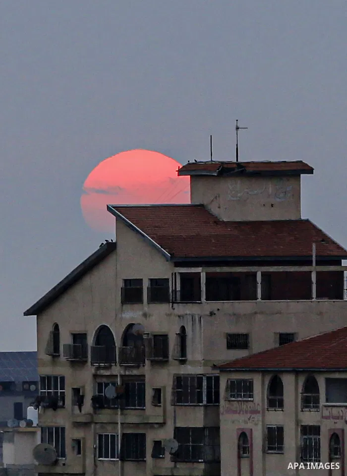 A general view shows the Gaza city during a Sunrise after an Israeli airstrike on May 9, 2023. At least 13 Palestinians, including children and women, were killed early this morning and many others injured in a series of...