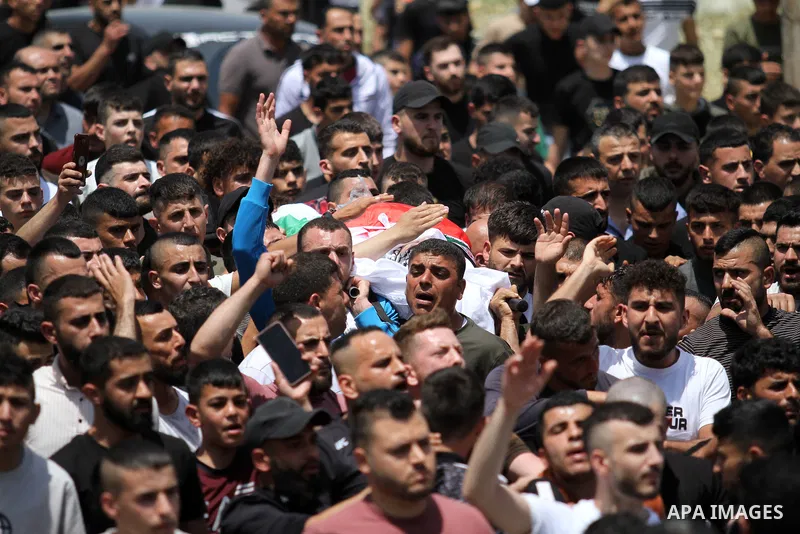 Palestinians carry the body of Aws Kamil, 30, who was died after he succumbed to his injuries sustained, during his funeral in the town of Qabatiya in the West Bank city of Jenin on May 11, 2023. Photo by Ahmed Ibrahim\...
