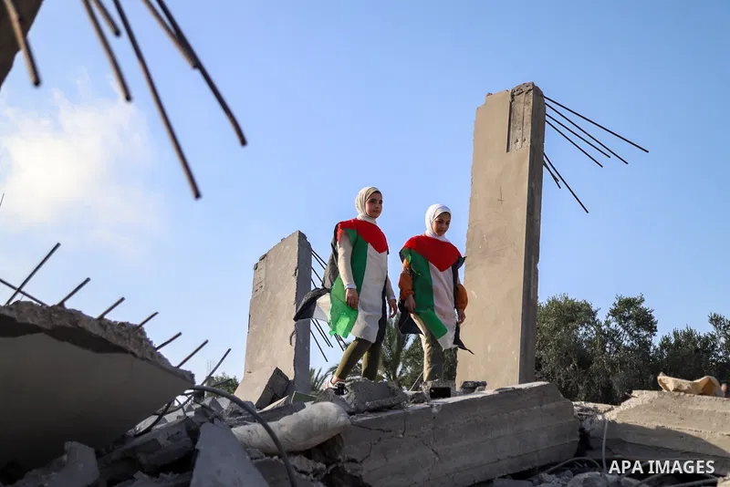 Palestinian children participate in an activity, aimed to support their mental health following the recent fighting between Islamic Jihad militant group in Gaza and Israel, near the site of an Israeli airstrike in Deir A...