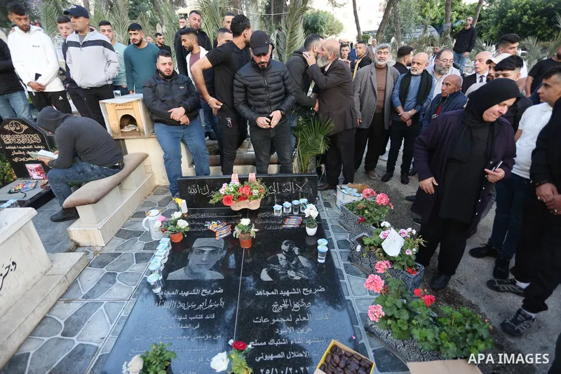 Palestinian families of people who were killed by Isareli forces visit graves of their relatives at a cemetery during the first day of Eid al-Fitr, in the west bank city of Nablus, on April 21, 2023. Muslims across the w...
