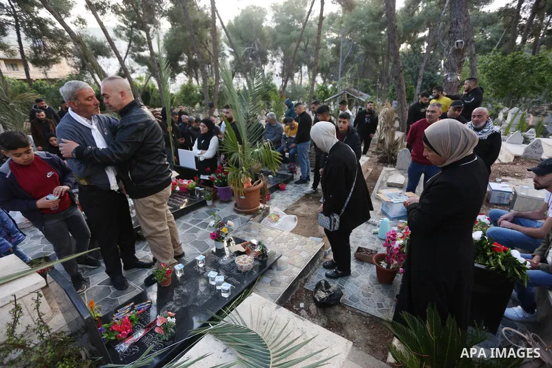 Palestinian families of people who were killed by Isareli forces visit graves of their relatives at a cemetery during the first day of Eid al-Fitr, in the west bank city of Nablus, on April 21, 2023. Muslims across the w...