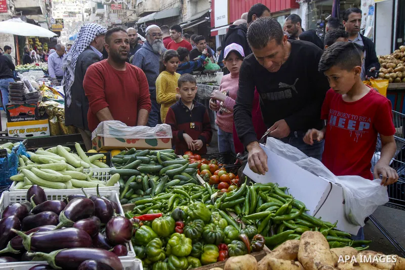 Palestinians shop at a market ahead of Eid al-Fitr which marks the end of the holy fasting month of Ramadan, in the West Bank city of Nablus on April 20, 2023. Eid Al Fitr 2023 is expected to fall on Friday, April 21, ma...