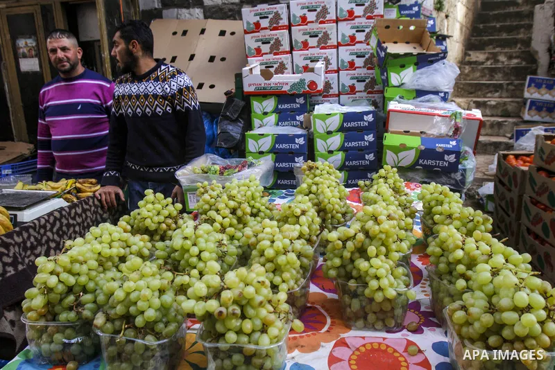 Palestinians shop at a market ahead of Eid al-Fitr which marks the end of the holy fasting month of Ramadan, in the West Bank city of Nablus on April 20, 2023. Eid Al Fitr 2023 is expected to fall on Friday, April 21, ma...