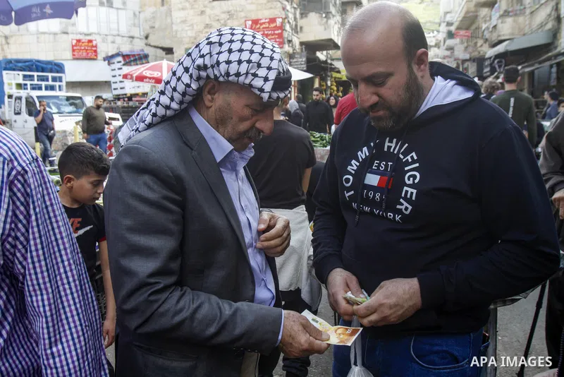 Palestinians shop at a market ahead of Eid al-Fitr which marks the end of the holy fasting month of Ramadan, in the West Bank city of Nablus on April 20, 2023. Eid Al Fitr 2023 is expected to fall on Friday, April 21, ma...