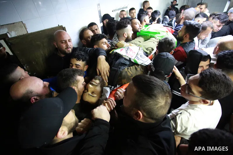 Palestinians carry the body of Mohammed Abu Bakr, who was killed during clashes with the Israeli army, during his funeral in the the West Bank city of Nablus on April 3, 2023. Two Palestinian youths have Monday been kill...