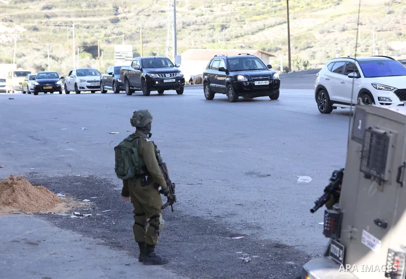 Israeli soldiers stand guard near the Jit junction west of Nablus in the northern West Bank on March 12, 2023. Three Palestinians were shot dead by Israeli forces this morning near the Jit junction west of Nablus in the...