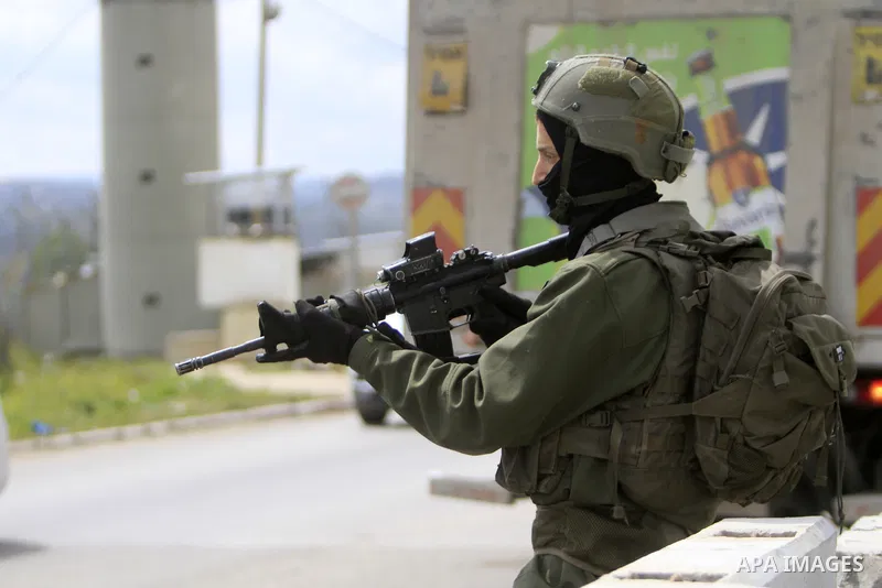 Israeli soldiers stand guard at Huwwara checkpoint south of Nablus, in the West Bank, on March 21, 2023. Photo by Mohammed Nasser\ apaimages