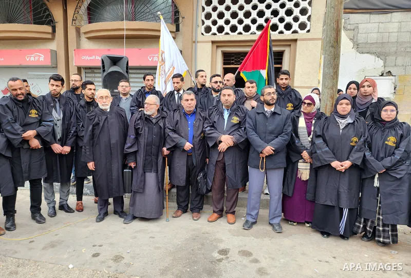 Palestinians of the Sharia Lawyers Syndicate take part in a protest following the killing of 11 Palestinians during an Israeli raid in Nablus, in front of the Syndicate headquarters in Gaza City on February 23, 2023. The...