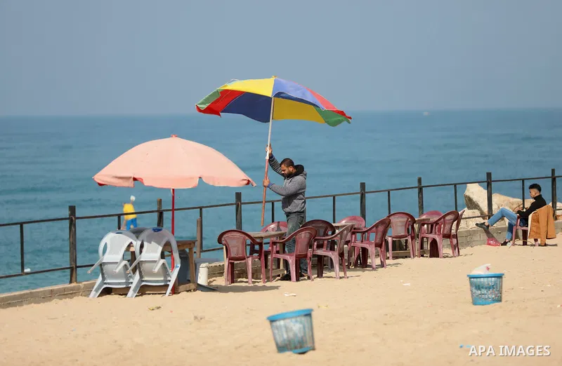Palestinians enjoy on the sea port of Gaza City, on February 20, 2023. Weather today in Palestine is clear and warm in daytime with a further rise in temperature, and very cold conditions are expected at nighttime especi...