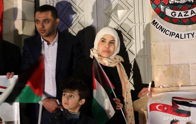 Palestinians light candles during a gathering in solidarity with the people of Turkey and Syria following a devastating earthquake, in Gaza city on Feb. 13, 2023. A 7.8-magnitude earthquake hit Turkey and Syria on Februa...
