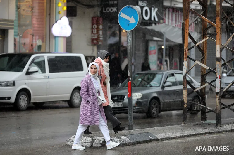 Palestinians walk in a flooded street following a heavy rain in Gaza city on February 07, 2023. Photo by Atia Darwish