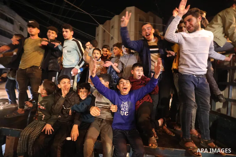 Palestinians shout slogans at a rally celebrating following reports that 7 Israelis were killed in a shooting attack in Jerusalem, in Khan Younis in the southern of Gaza stip on January 27, 2023. Israeli emergency servic...