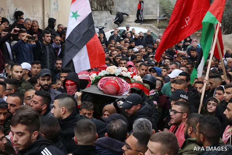 Palestinians carry the body of Omar Khmour, 14, who was died of his wounds following shot by Israeli forces, during his funeral in the West Bank city of Bethlehem on January 16, 2023. Khmour is the fourth child killed by...