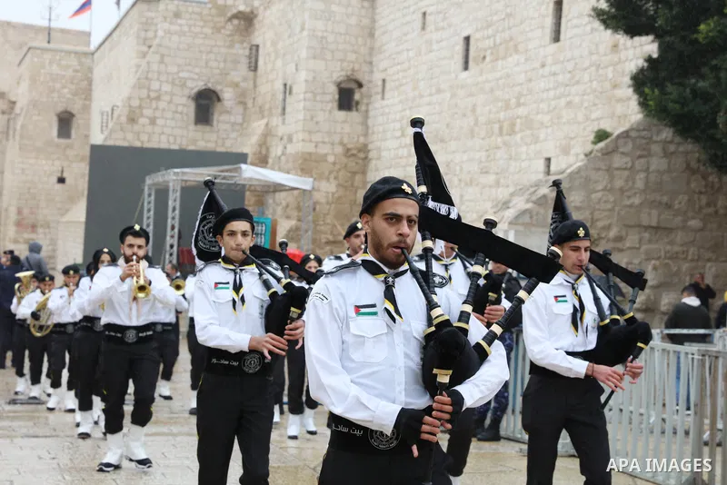 Palestinian scout bands parade during Christian denominations celebrate Christmas according to the Eastern calendar around the Nativity Church in the biblical city of Bethlehem, on January 6, 2023. Photo by Ahmad Tayem/A...