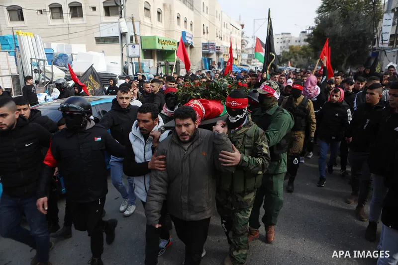 Palestinian mourners carry the body of 15-year-old Adam Ayyad during his funeral at Bethlehem's Dheisheh refugee camp in the West Bank on January 3, 2023. Israeli forces killed the teenager according to the Palestinian h...