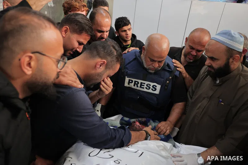 Al Jazeera's bureau chief in Gaza, Wael Al-Dahdouh is comforted during the funeral of his son Hamza Wael Dahdouh, a journalist with the Al Jazeera television network, who was killed in a reported Israeli air strike, in R...