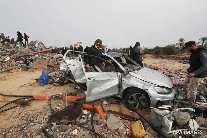 Residents and civil defense teams carry out a search and rescue operation around the rubble of the building demolished after Israeli attack in El-Zawaida, Gaza on January 29, 2024. Many buildings were destroyed or heavil...