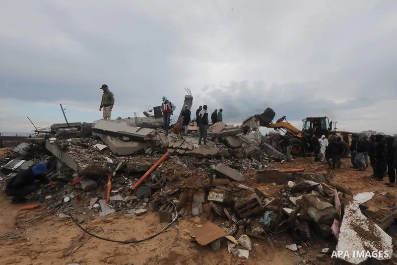 Residents and civil defense teams carry out a search and rescue operation around the rubble of the building demolished after Israeli attack in El-Zawaida, Gaza on January 29, 2024. Many buildings were destroyed or heavil...