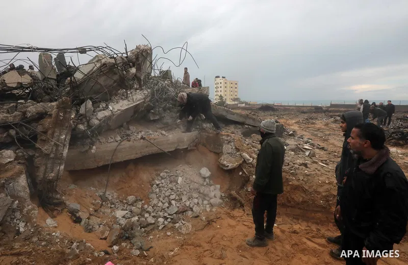 Residents and civil defense teams carry out a search and rescue operation around the rubble of the building demolished after Israeli attack in El-Zawaida, Gaza on January 29, 2024. Many buildings were destroyed or heavil...