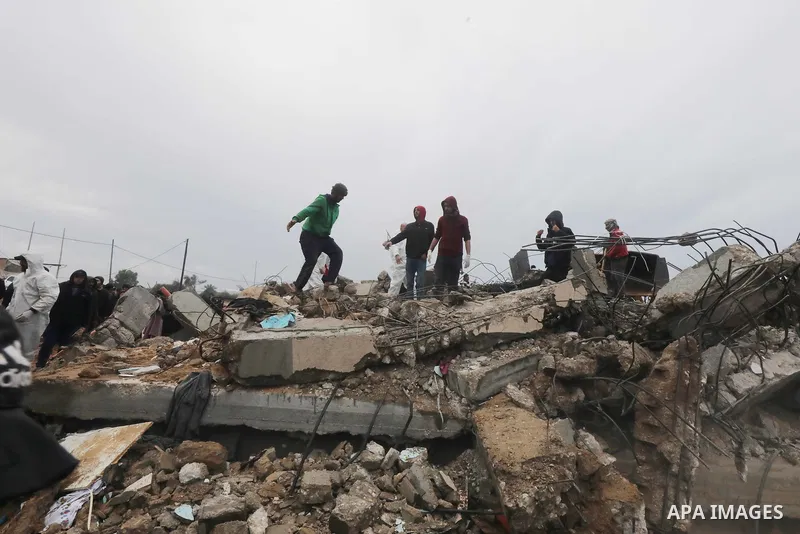 Residents and civil defense teams carry out a search and rescue operation around the rubble of the building demolished after Israeli attack in El-Zawaida, Gaza on January 29, 2024. Many buildings were destroyed or heavil...