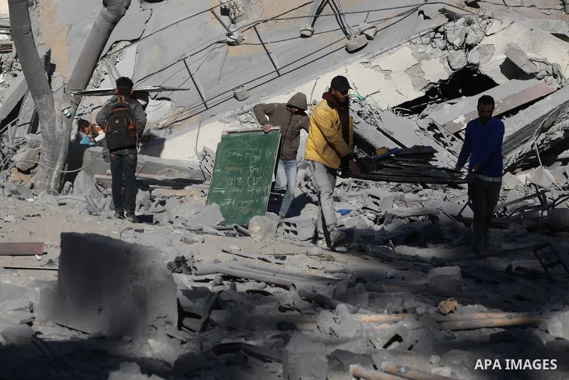 Palestinians inspect amid the rubble of Al-Urube school following the Israeli attack on the Nuseirat refugee camp in Deir al-Balah, Gaza on January 31, 2024. Photo by Naaman Omar\ apaimages