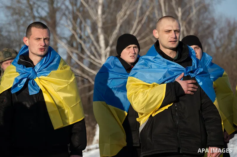 Ukrainian former prisoners of war wrapped in a Ukrainian flag, following a prisoner exchange, amid Russia's military invasion on Ukraine. Russia and Ukraine exchanged hundreds of prisoners of war on January 31, just a we...