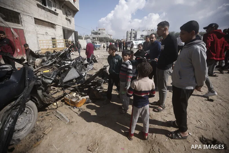 Palestinians inspect a destroyed car following the Israeli attacks in Rafah, Gaza on February 10, 2024. Photo by Bashar Taleb\ apaimages