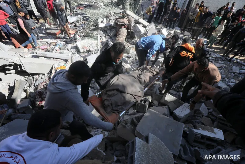 Locals conduct search and rescue operations among the rubble of buildings destroyed by an Israeli attack on Zawaida in Deir al Balah, Gaza on February 22, 2024. Photo by Omar Ashtawy\ apaimages