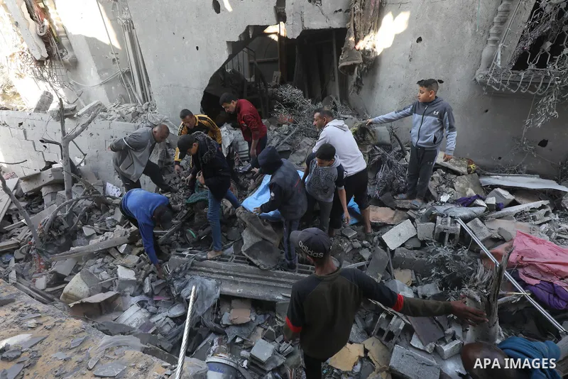 Locals conduct search and rescue operations among the rubble of buildings destroyed by an Israeli attack on Zawaida in Deir al Balah, Gaza on February 22, 2024. Photo by Omar Ashtawy\ apaimages