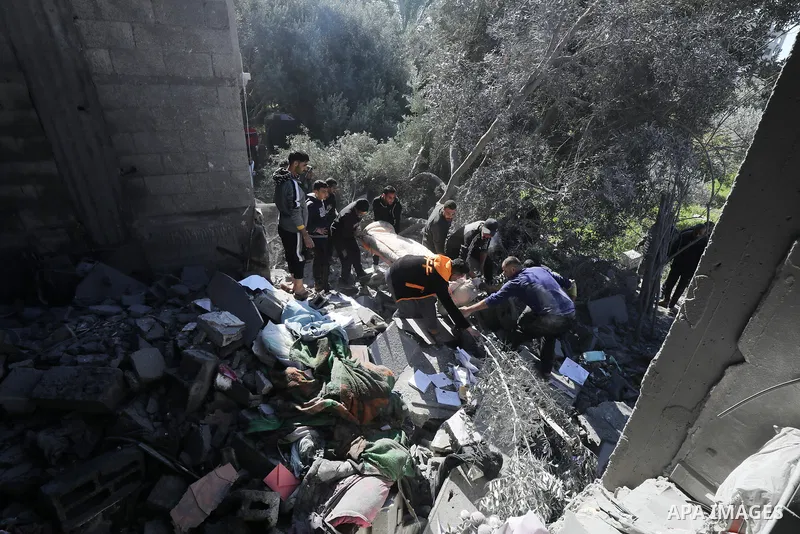 Locals conduct search and rescue operations among the rubble of buildings destroyed by an Israeli attack on Zawaida in Deir al Balah, Gaza on February 22, 2024. Photo by Omar Ashtawy\ apaimages
